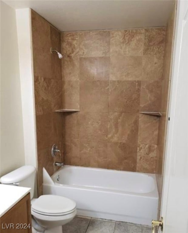 full bathroom featuring tile patterned flooring, toilet, tiled shower / bath combo, and vanity