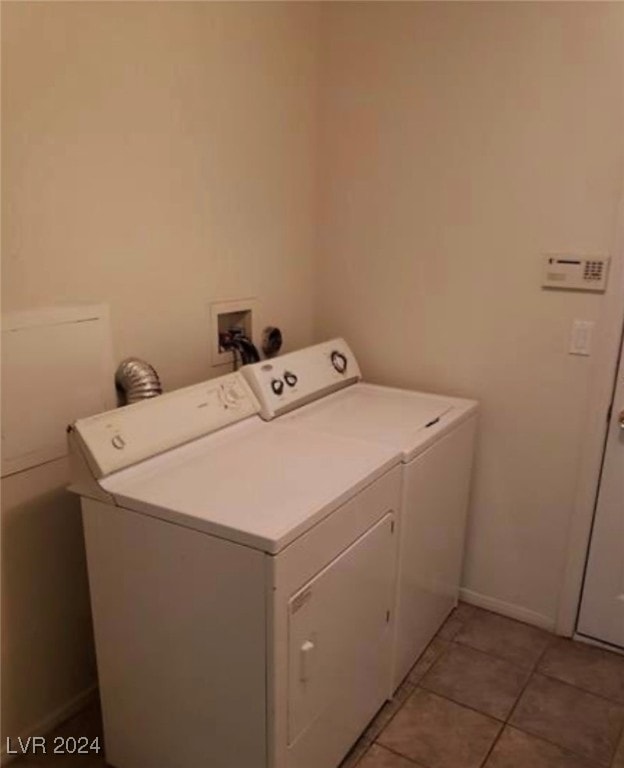 washroom with light tile patterned floors and washing machine and clothes dryer