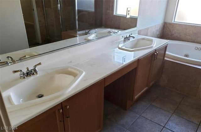 bathroom with tiled bath, dual bowl vanity, and tile patterned floors