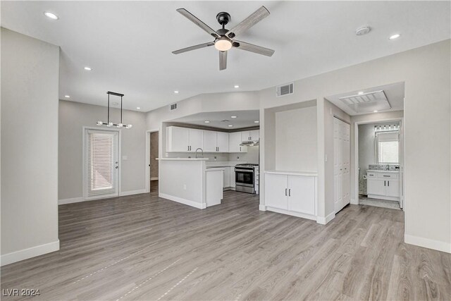 unfurnished living room with sink, ceiling fan, and light wood-type flooring