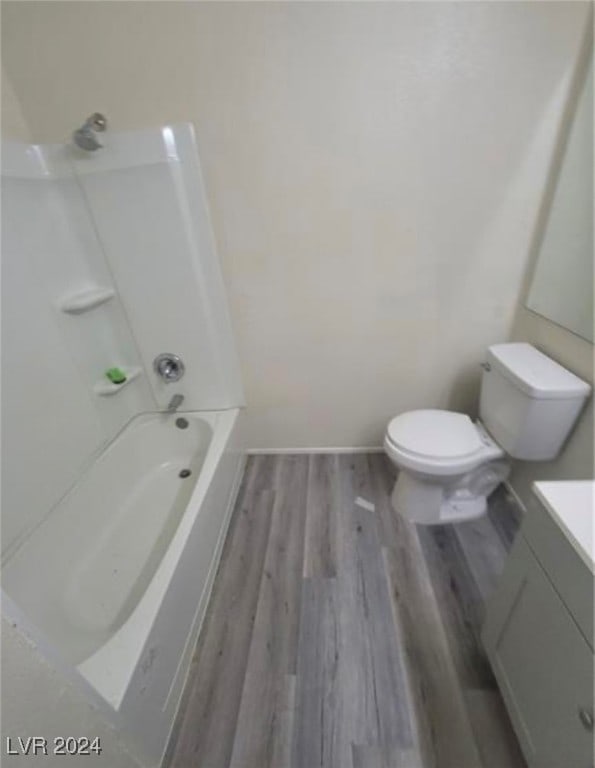 full bathroom with toilet, hardwood / wood-style flooring, shower / bathing tub combination, and vanity