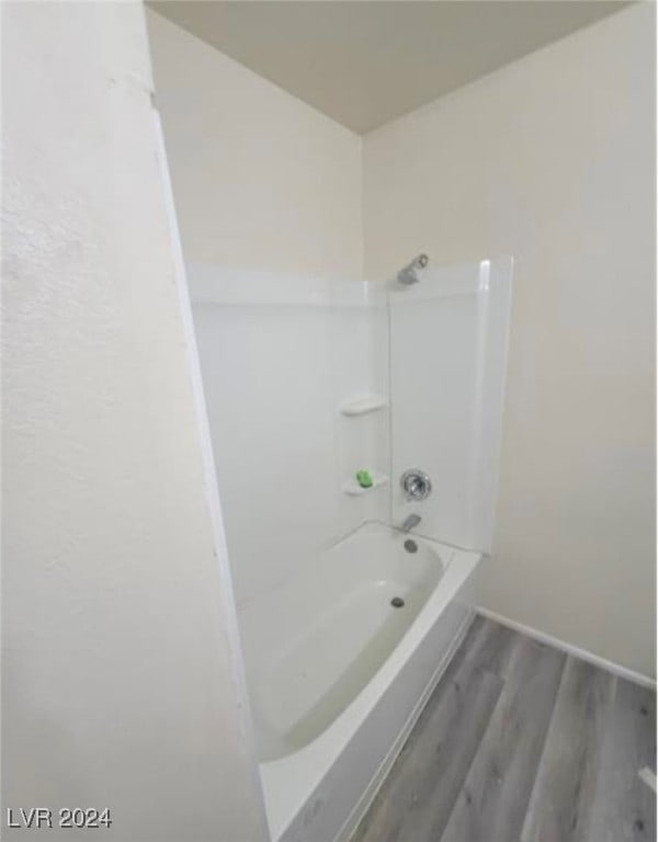 bathroom featuring shower / washtub combination and wood-type flooring