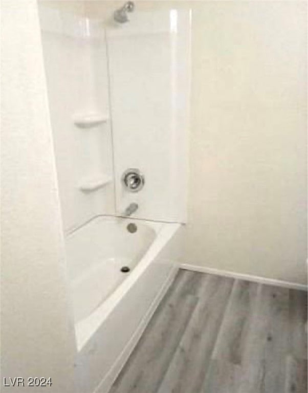 bathroom featuring hardwood / wood-style floors and shower / bathing tub combination