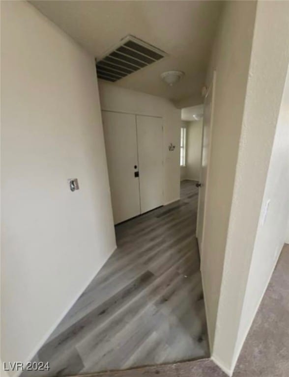 hallway with wood-type flooring