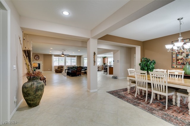 dining room with ceiling fan with notable chandelier and light tile patterned floors