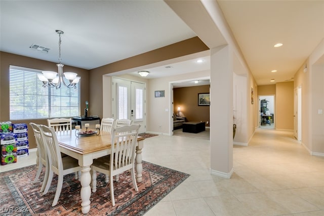 dining room featuring a notable chandelier and light tile patterned floors