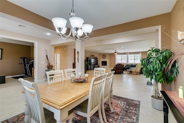 tiled dining space with an inviting chandelier