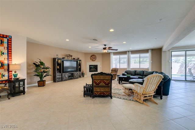 tiled living room featuring ceiling fan