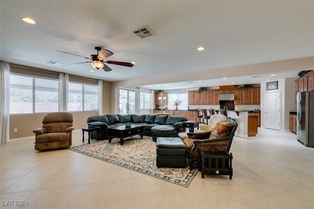 tiled living room with ceiling fan