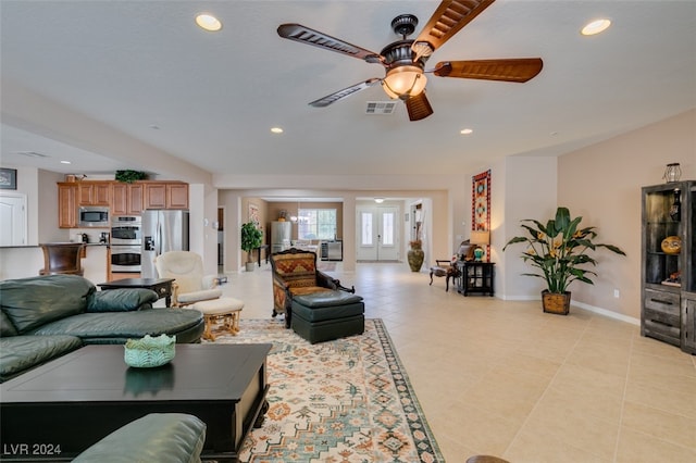 tiled living room featuring ceiling fan