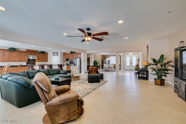 tiled living room featuring ceiling fan