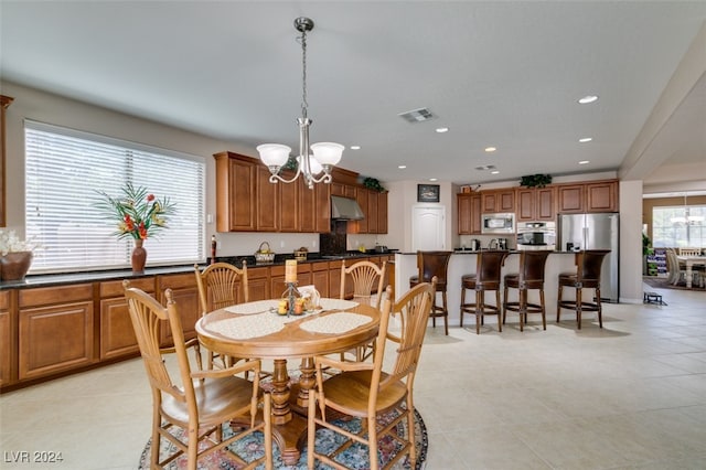 dining space with a notable chandelier and light tile patterned floors