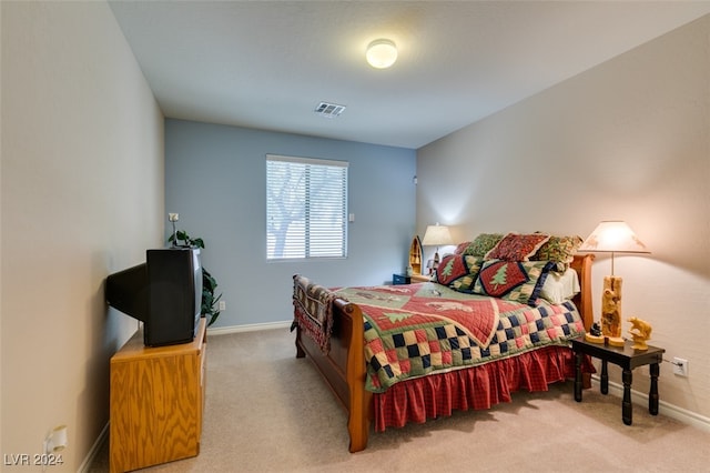 bedroom featuring light carpet