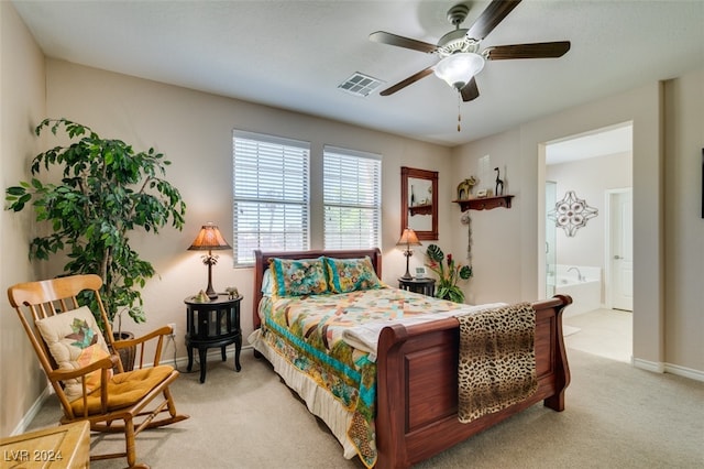 carpeted bedroom with ceiling fan and ensuite bath