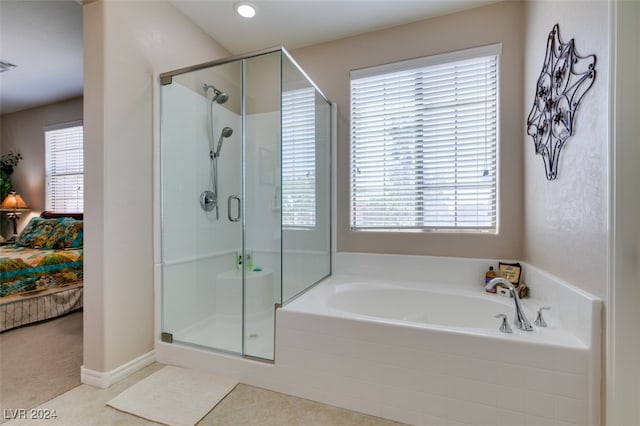 bathroom with tile patterned floors and shower with separate bathtub