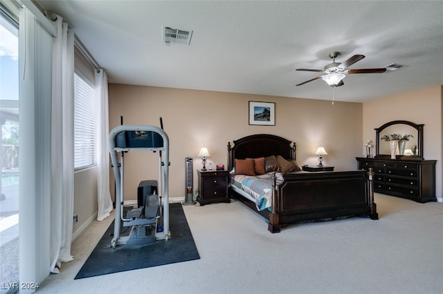 bedroom with ceiling fan and light carpet