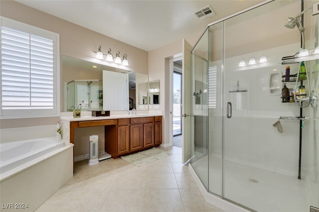 bathroom with tile patterned flooring, shower with separate bathtub, vanity, and a wealth of natural light