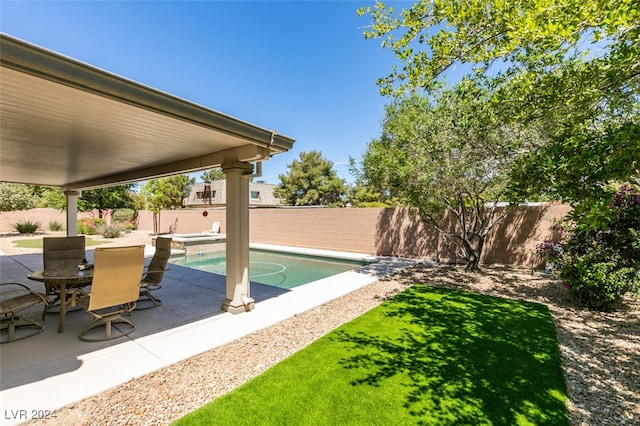 view of yard with a fenced in pool and a patio