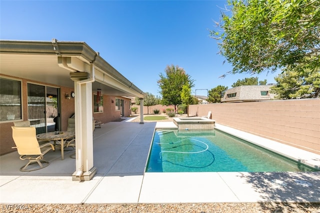 view of swimming pool with a jacuzzi and a patio