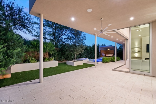 view of patio / terrace featuring ceiling fan and an outdoor living space