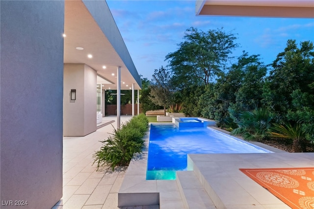 view of pool featuring a patio area and an in ground hot tub