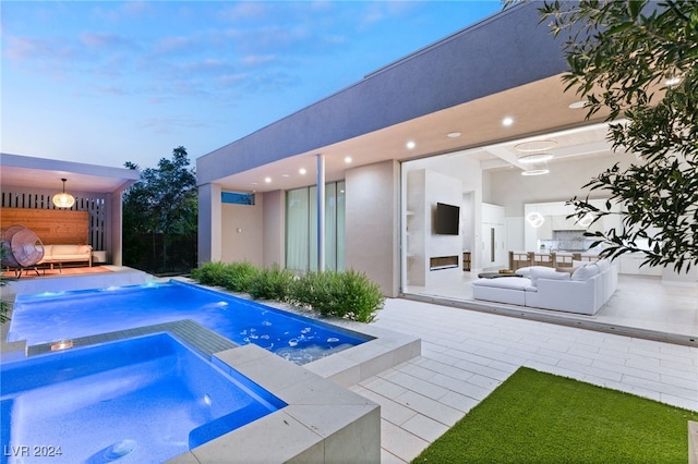 view of swimming pool featuring an in ground hot tub, outdoor lounge area, and a patio area