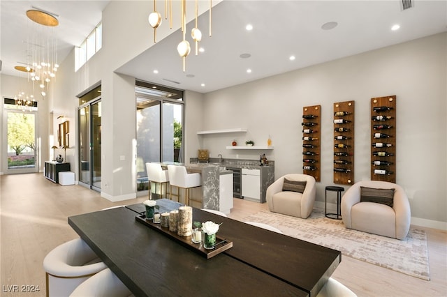 dining area featuring light hardwood / wood-style flooring, an inviting chandelier, and plenty of natural light