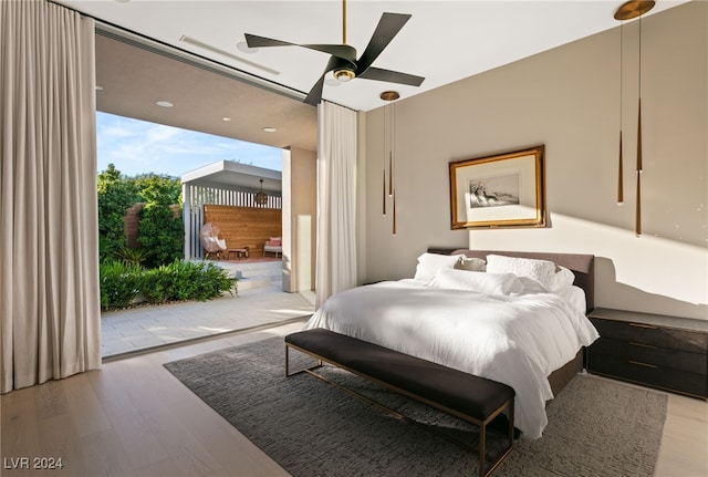 bedroom with ceiling fan, light hardwood / wood-style floors, and access to outside