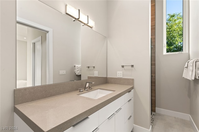 bathroom with tile patterned flooring and vanity