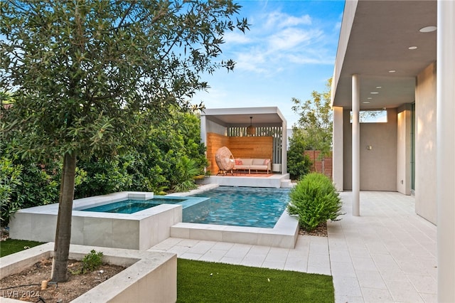 view of pool featuring an in ground hot tub and a patio area