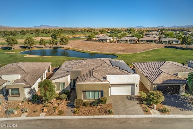 drone / aerial view featuring a water and mountain view