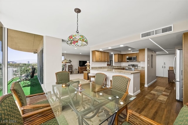 dining area with dark hardwood / wood-style floors