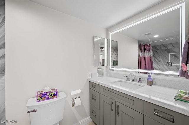 bathroom featuring a shower with curtain, vanity, and toilet