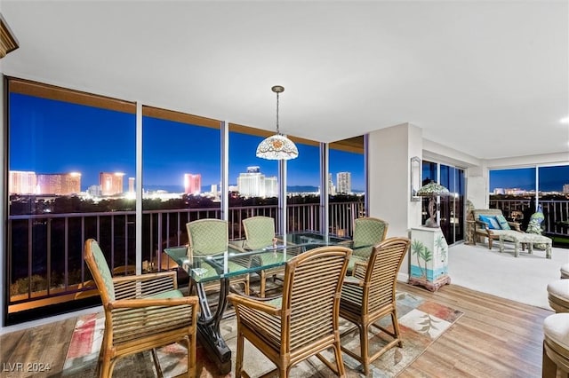 3111 Bel Air Dr Unit 8A, Las Vegas, NV 89109 - dining area featuring wood finished floors and a city view