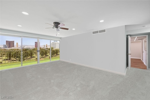 3111 Bel Air Dr Unit 8A, Las Vegas, NV 89109 - carpeted empty room with ceiling fan, recessed lighting, baseboards, and a view of city