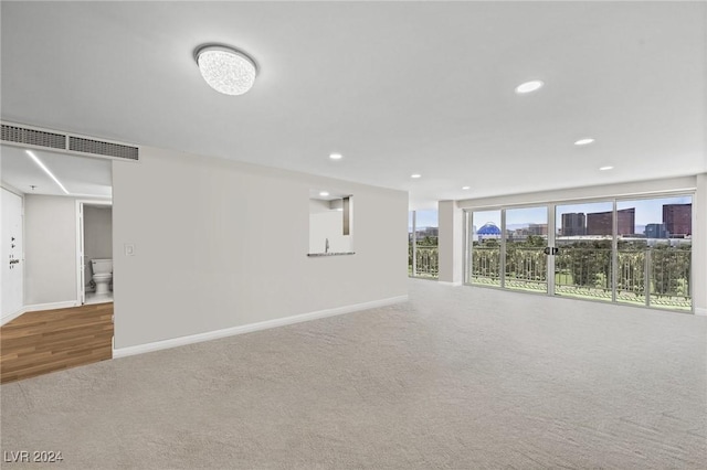 3111 Bel Air Dr Unit 8A, Las Vegas, NV 89109 - basement with baseboards, carpet, recessed lighting, and wood finished floors