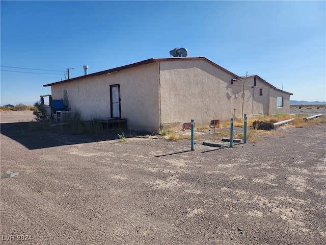 rear view of house featuring central air condition unit