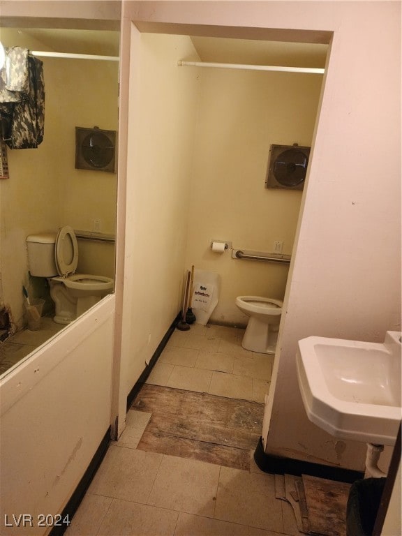 bathroom featuring sink, toilet, and tile patterned floors