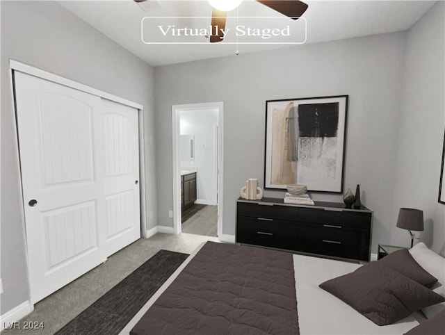 bedroom featuring a closet, ceiling fan, light colored carpet, and ensuite bath