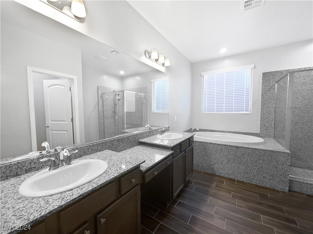 bathroom with separate shower and tub and vanity