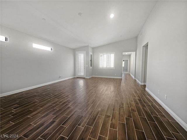 unfurnished living room featuring dark hardwood / wood-style flooring and lofted ceiling