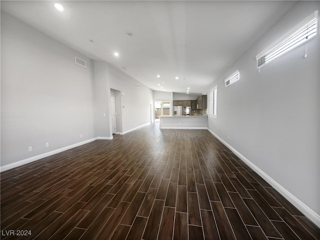 unfurnished living room featuring dark wood-type flooring