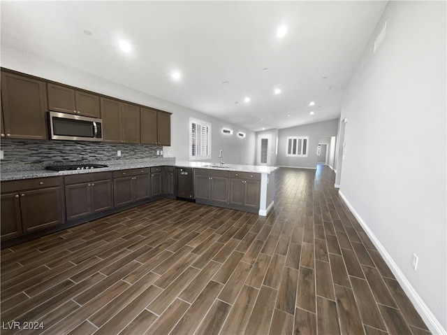 kitchen with backsplash, sink, dark wood-type flooring, gas stovetop, and dark brown cabinets