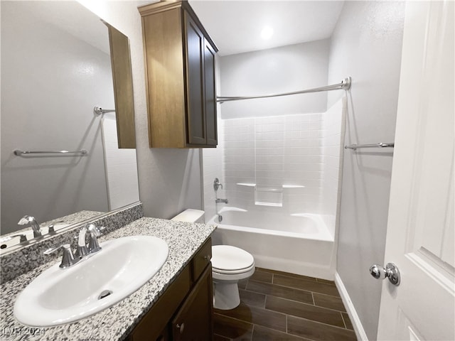 full bathroom with tile patterned floors, washtub / shower combination, vanity, and toilet