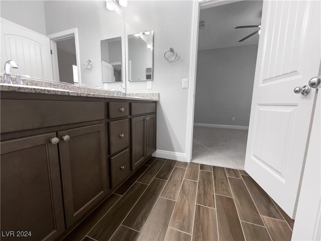 bathroom featuring ceiling fan, hardwood / wood-style floors, and vanity