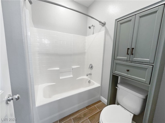 bathroom featuring tile patterned flooring, toilet, and shower / bathtub combination