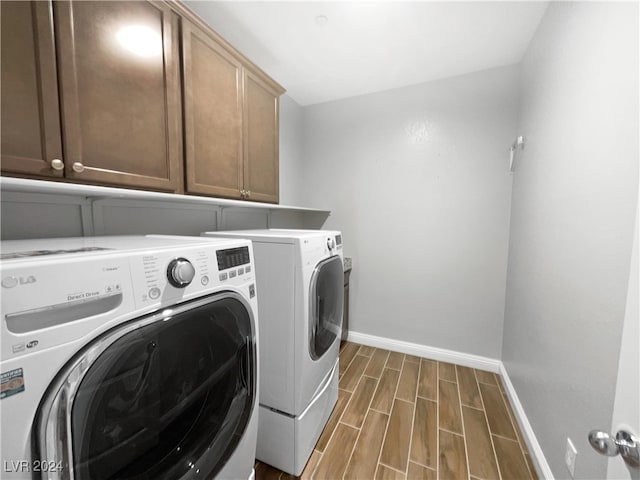 laundry area featuring cabinets, separate washer and dryer, and dark hardwood / wood-style floors