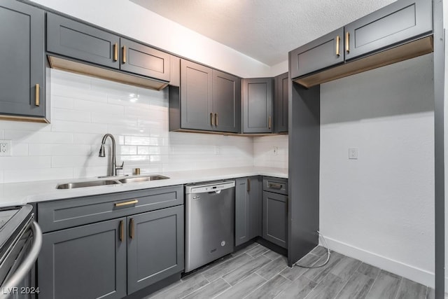 kitchen with light hardwood / wood-style flooring, stainless steel dishwasher, tasteful backsplash, range, and sink