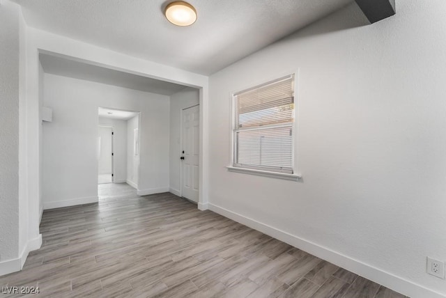 unfurnished room with wood-type flooring