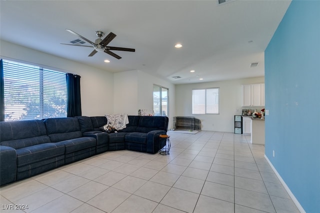 tiled living room with ceiling fan